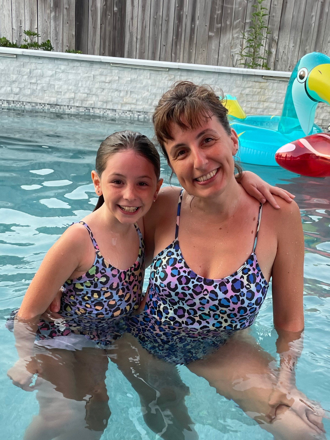 Lily and Kat smiling together in the pool